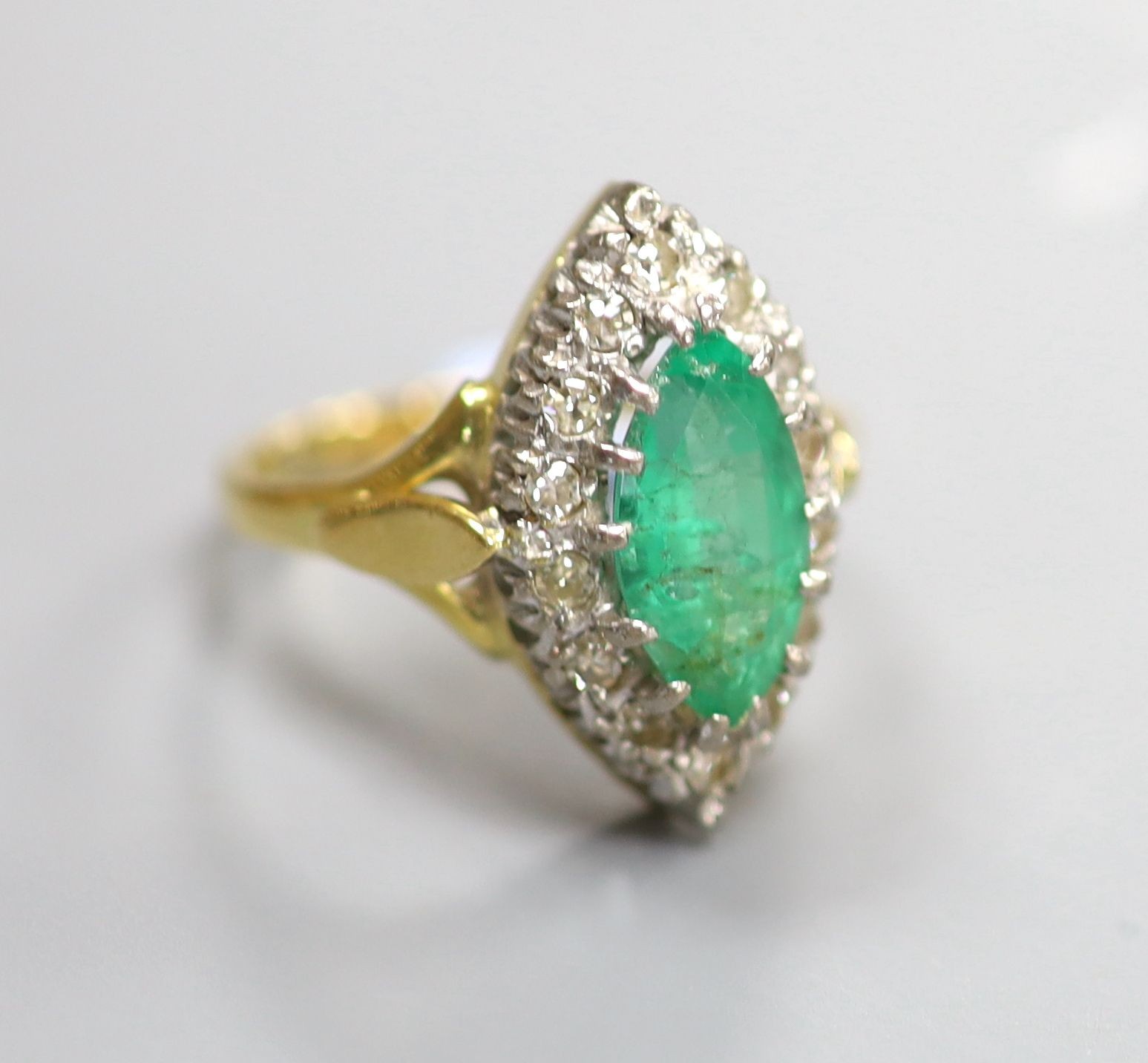 A modern Victorian style 18ct gold, emerald and diamond marquise set dress ring, size L, gross 5.9 grams.